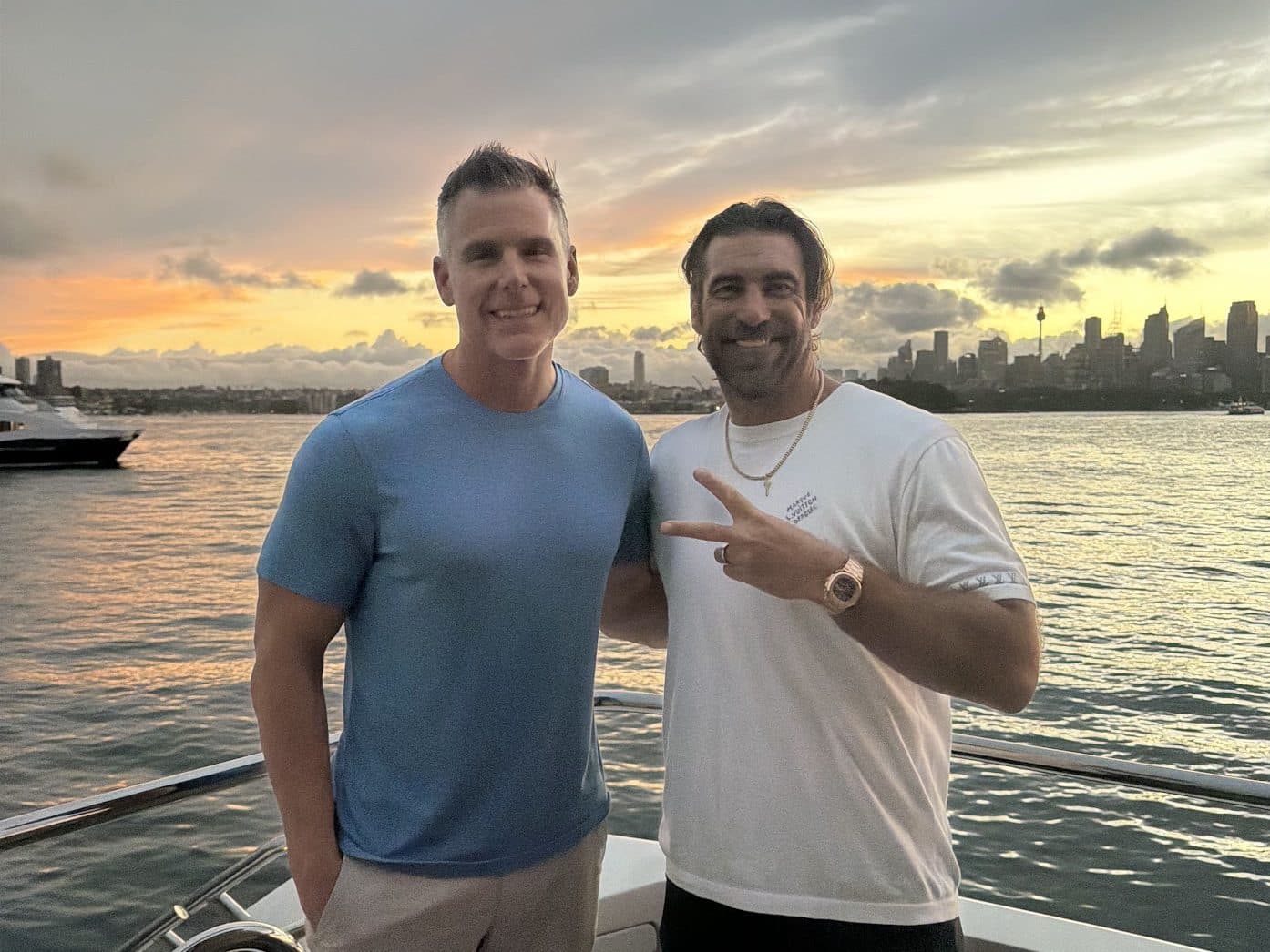 Josh Zieglowsky with Dan Martell on a boat at sunset