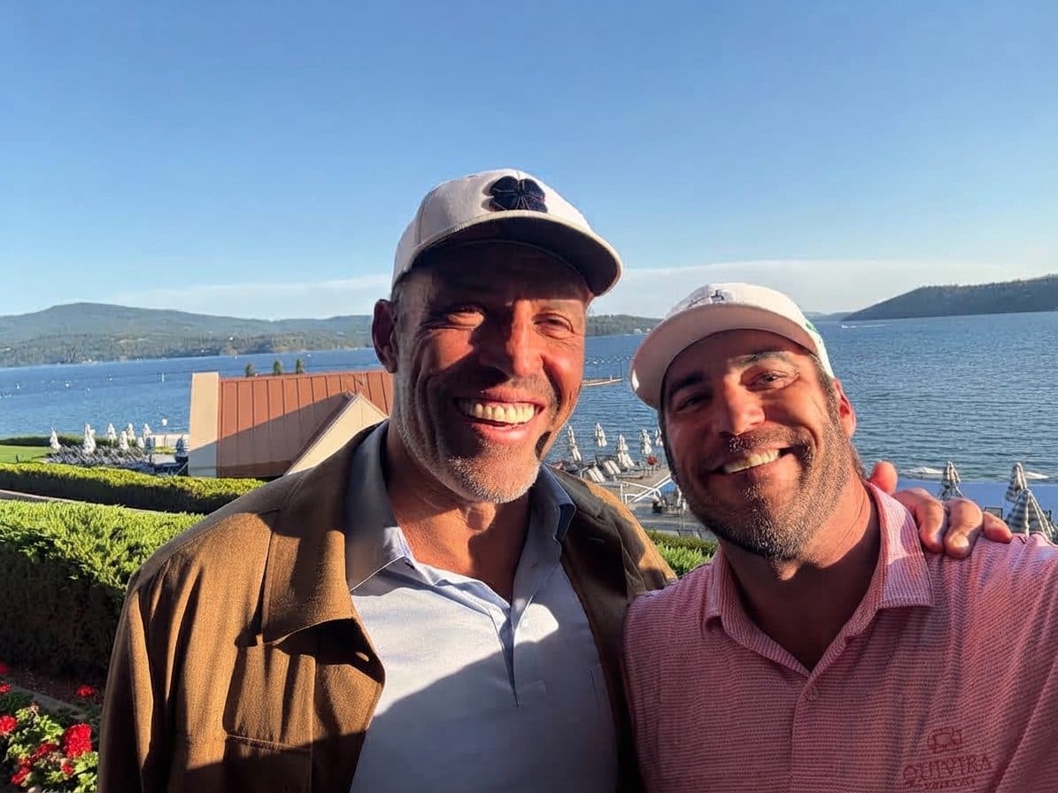 Josh Zieglowsky and Tony Robbins outdoors at an event